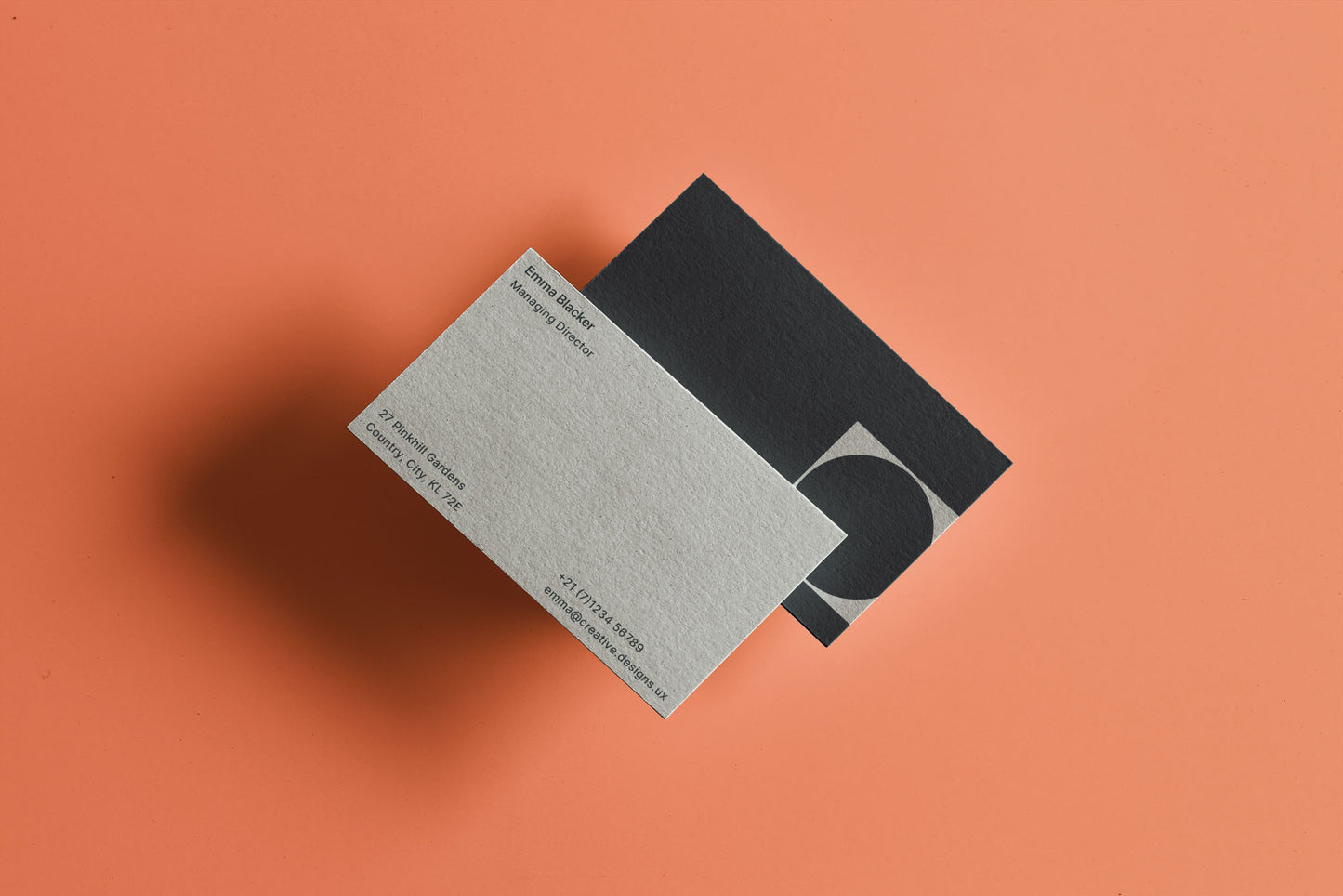 One black and one grey business card, both custom made through layout website