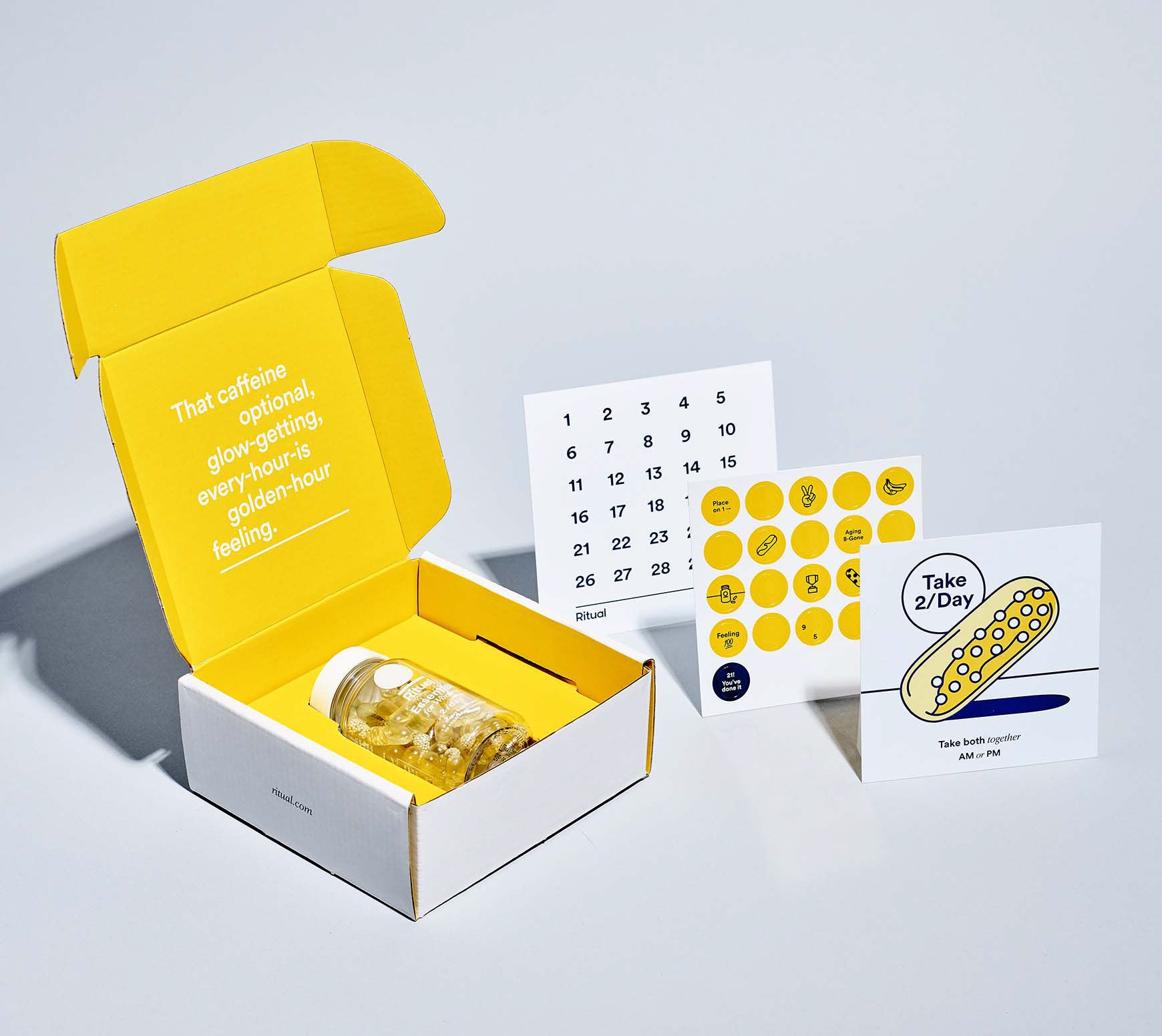 Custom gift set box in grey and yellow color. Calendar and circle stickers on the right. 