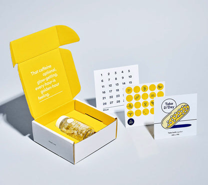 Custom gift set box in grey and yellow color. Calendar and circle stickers on the right. 